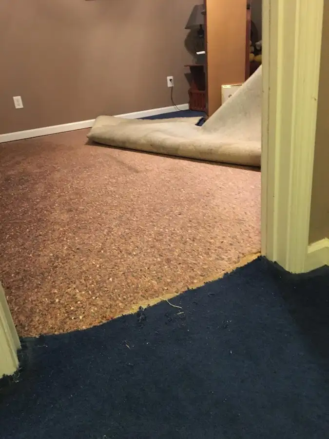 Carpet pad removal revealing water damage during Water Mitigation Services in Corona de Tucson